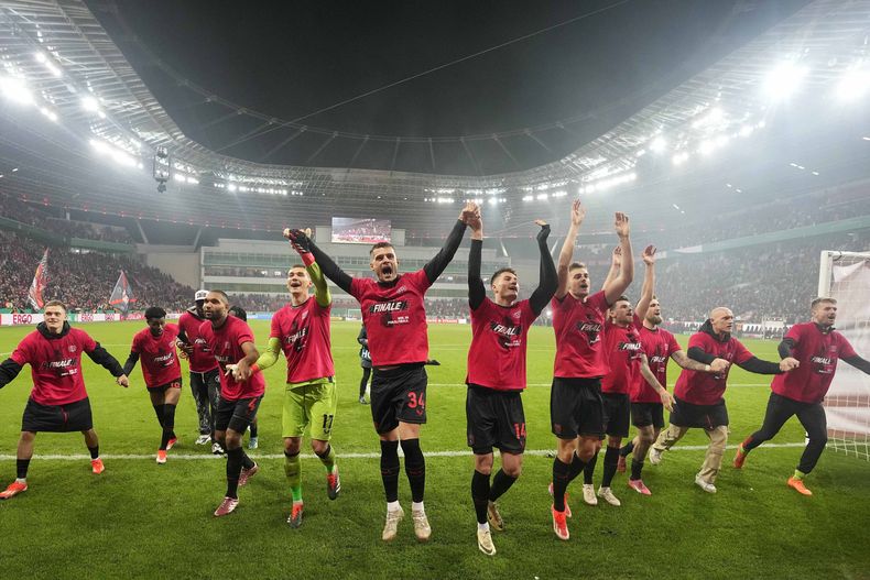 Granit Xhaka (centro) celebra con sus compañeros del Bayer Leverkusen tras derrotar a Fortuna Duesseldorf, el 3 de abril de 2024. (AP Foto/Martin Meissner)