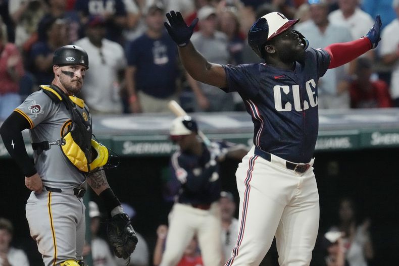Jhonkensy Noel, derecha, de los Guardianes de Cleveland, celebra frente al receptor de los Piratas de Pittsburgh Yasmani Grandal, después de batear jonrón en la quinta entrada del juego de béisbol del viernes 30 de agosto de 2024, en Cleveland. (AP Foto/Sue Ogrocki)