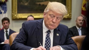 ARCHIVO - El presidente Donald Trump firma una orden ejecutiva en el Salón Roosevelt de la Casa Blanca en Washington, el 25 de abril de 2017. (AP Foto/Andrew Harnik, Archivo)
