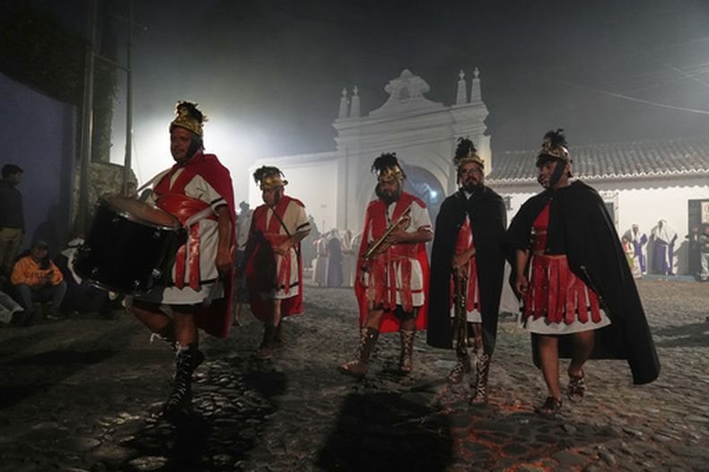 Músicos vestidos como soldados romanos participan en la procesión del Viernes Santo de la iglesia de La Merced durante la Semana Santa en Antigua, Guatemala, el viernes 3 de abril de 2026. (AP Foto/Moises Castillo)