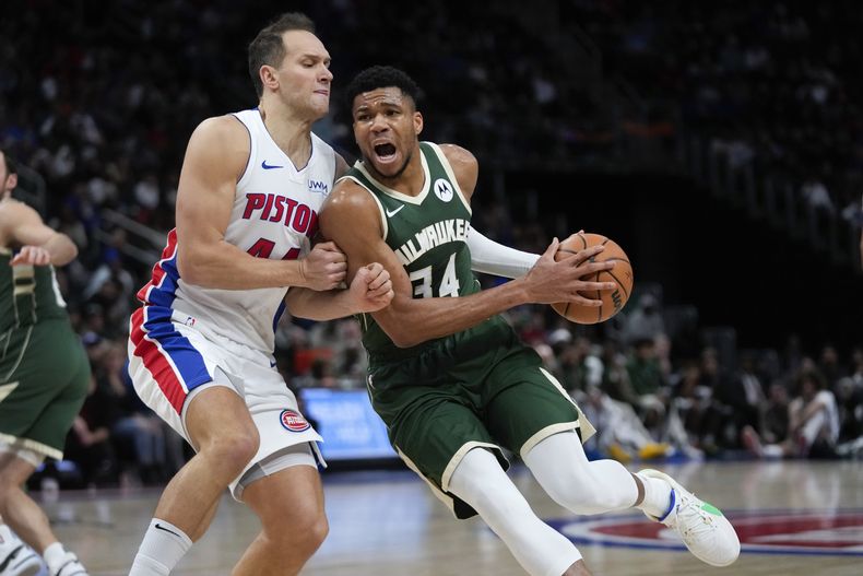 Giannis Antetokounmpo (34), de los Bucks de Milwaukee, pelea la posición de campo con Bojan Bogdanovic (44), de los Pistons de Detroit, durante la primera mitad del juego de baloncesto de la NBA, en Detroit, el lunes 22 de enero de 2024. (AP Foto/Paul Sancya)
