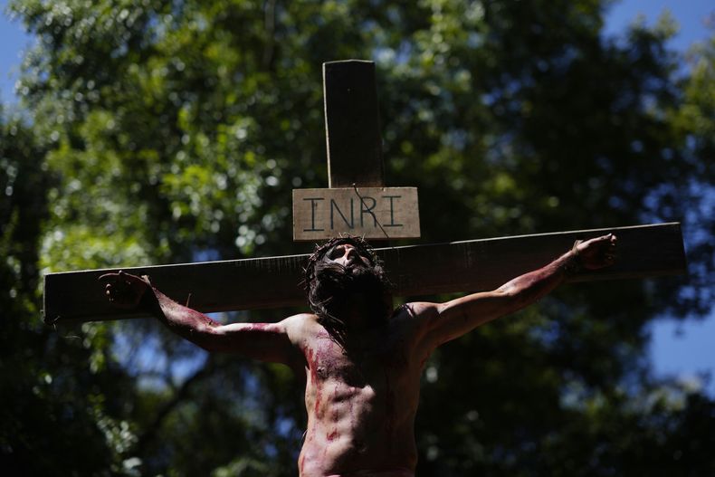 Un actor que interpreta a Jesucristo, colgado en una cruz durante una representación del Via Crucis, con motivo de la Semana Santa, en Atyra, Paraguay, el 29 de marzo de 2024. La Semana Santa conmemora los últimos días de la vida de Jesús, según la Biblia, incluyendo su crucifixión el Viernes Santo y su resurrección en el Domingo de Pascua. (AP Foto/Jorge Sáenz)