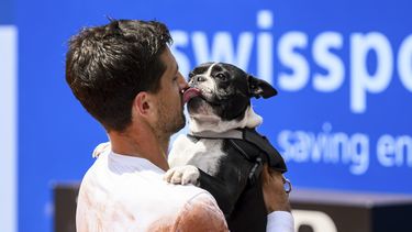 El campeón Pedro Cachín besa a su perro Tango tras derrotar a Albert Ramos-Viñolas en la final del Abierto de Suiza en Gstaad, el domingo 23 de julio de 2023. (Jean-Christophe Bott/Keystone vía AP)