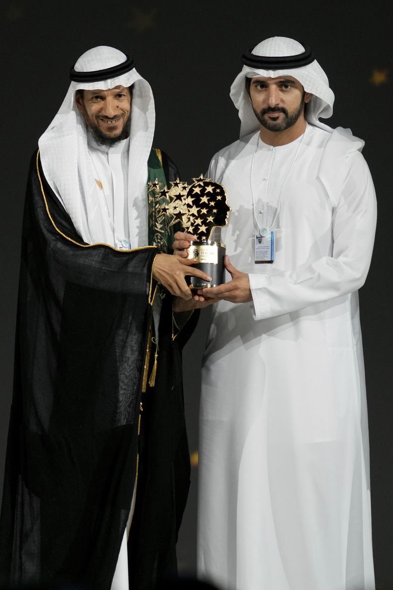 El maestro saudí Mansour bin Abdullah Al-Mansour, a la izquierda, recibe el trofeo del Premio Global de Enseñanza del príncipe heredero de Dubái, el jeque Hamdan bin Mohammed Al Maktoum, en una ceremonia de entrega del Premio Global de Enseñanza en Dubái, Emiratos Árabes Unidos, el jueves 13 de febrero de 2025. (AP Foto/Altaf Qadri)