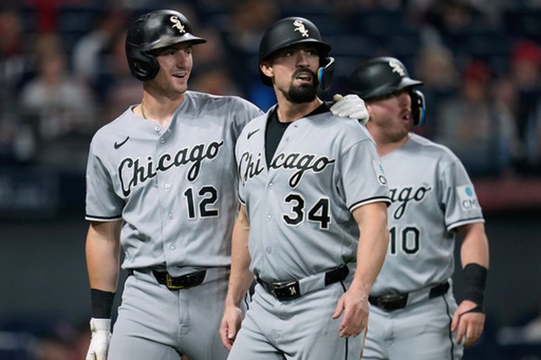 El pelotero de los Medias Blancas de Chicago Colson Montgomery (12), Randal Grichuk (34) y Chase Meidroth (10) regresan a la cueva después de que Montgomery y Meidroth anotaran y Grichuk fuera puesto out en el plato en un batazo de doble dobles conectado por Kyle Teel durante la sexta entrada de un partido de béisbol en Cleveland, el lunes 14 de septiembre de 2026. (Foto AP/Sue Ogrocki)