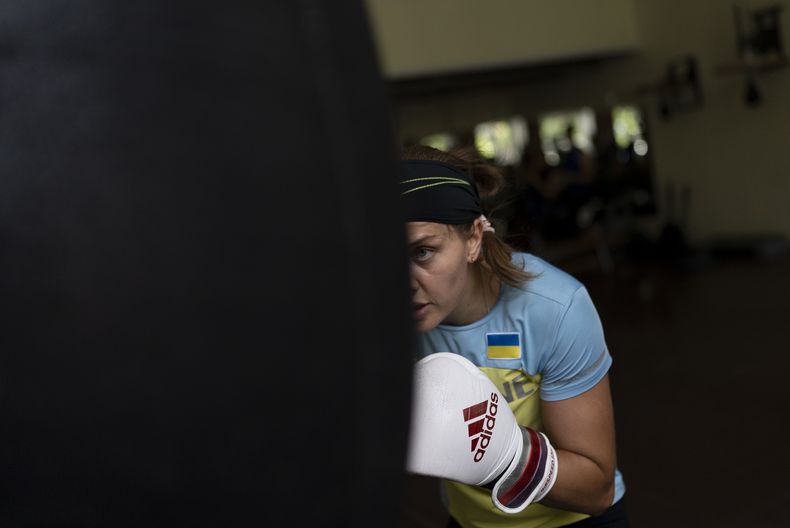 La boxeadora ucraniana Anna Lysenko golpea el saco durante un entrenamiento en el Kiko Boxing Club de Kiev, Ucrania, el martes 11 de julio de 2023. (AP Foto/Jae C. Hong)