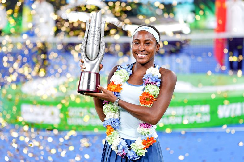 La estadounidense Coco Gauff celebra con el trofeo de campeona de Wuhan tras vencer a su compatriota Jessica Pegula en la final el domingo 12 de octubre del 2025. (Chinatopix Via AP) CHINA OUT