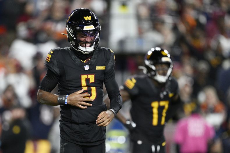 Jayden Daniels (5), quarterback de los Commanders de Washington hace un gesto de dolor después de una jugada en la segunda mitad del partido de la NFL en contra de los Bears de Chicago, el domingo 27 de octubre de 2024, en Landover, Maryland. (AP Foto/Nick Wass)