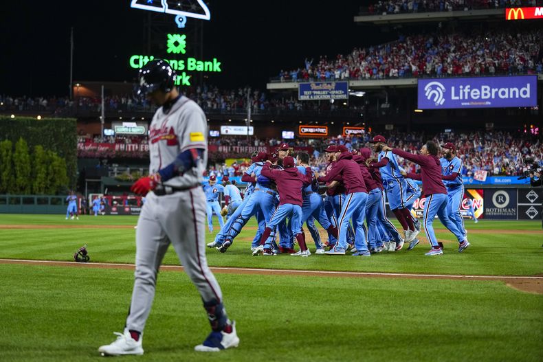 Los Filis de Filadelfia festejan tras eliminar a los Bravos de Atlanta en el cuarto juego de la serie divisional de la Liga Nacional, el jueves 12 de octubre de 2023 (AP foto/Matt Rourke)