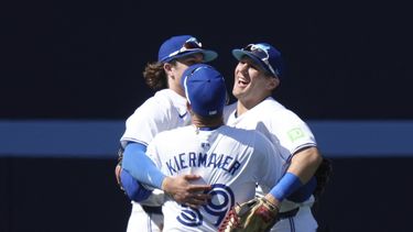 Los jardineros de los Azulejos de Toronto, Daulton Varsho, derecha, Kevin Kiermaier, centro y Addison Barger, izquierda, celebran después de conseguir la victoria sobre los Guardianes de Cleveland en el juego de béisbol en Toronto, el domingo 16 de junio de 2024. (Chris Young/The Canadian Press vía AP)