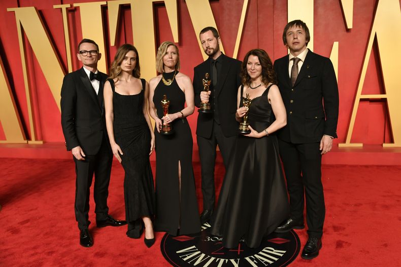 Derl McCrudden, de izquierda a derecha, Vasilisa Stepanenko, Michelle Mizner, Mstyslav Chernov, Raney Aronson-Rath, y Evgeniy Maloletka llegan a la fiesta de Vanity Fair tras los Oscar el domingo 10 de marzo de 2024, en el Centro Wallis Annenberg para las Artes Escénicas en Beverly Hills, California. (Foto Evan Agostini/Invision/AP)