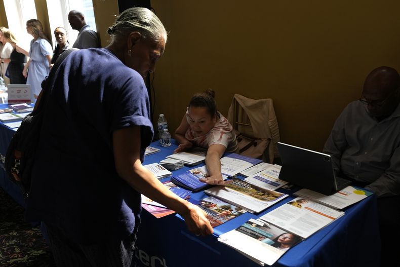 Una mujer muestra panfletos en una exhibición sobre maneras de mejorar la salud de la población de raza negra, en Harlem, en la ciudad de Nueva York, el 15 de agosto del 2024. (Foto AP/Pamela Smith)