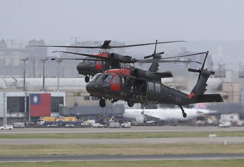 FILE - Two Sikorsky UH-60 Black Hawk helicopters approach during the annual Han Kuang military exercises that simulates an attack on an airfield at Taoyuan International Airport in Taoyuan, northern Taiwan, Wednesday, July 26, 2023. (AP Photo/ Chiang Ying-ying)