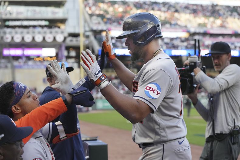 El cubano José Abreu de los Astros de Houston es felicitado por sus compañeros en el banquillo luego de un jonrón de 2 carreras en la 9na entrada del Juego 3 de la Serie Divisional de la Liga Americana ante los Mellizos de Minnesota, el martes 10 de octubre de 2023, en Mineápolis. (AP Foto/Jordan Johnson)