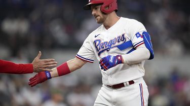 Robbie Grossman, de los Rangers de Texas, festeja tras conectar un sencillo productor ante los Rockies de Colorado, el sábado 20 de mayo de 2023 (AP Foto/LM Otero)