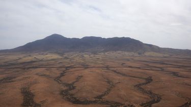 Un helicóptero Blackhawk del ejército de Estados Unidos vuela cerca de la frontera con México dentro de la Fuerza de Tarea Conjunta Frontera Sur el jueves 3 de abril de 2025, en Douglas, Arizona. La línea del muro fronterizo puede verse a la mitad de la foto. (AP Foto/Ross D. Franklin)