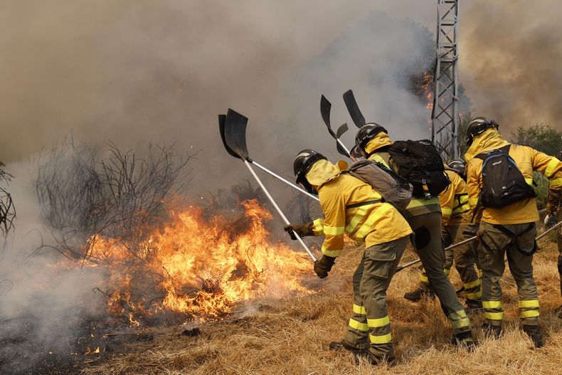 ARCHIVO - Bomberos combaten un fuego forestal en Veiga das Meas, en el noroeste de España, el sábado 16 de agosto de 2025. (AP Foto/Lalo R. Villar, Archivo)