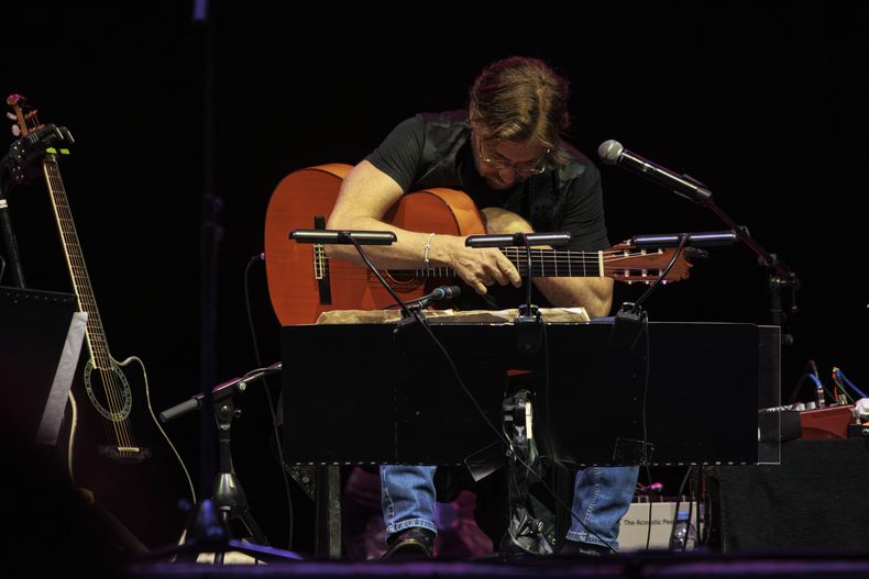 El guitarrista estadounidense Al Di Meola se toca el pecho poco antes de salir con dificultades del escenario en el foro Arenele Romane en Bucarest, Rumania, el 27 de septiembre de 2023. Di Meola sufrió un infarto durante una actuación en la capital rumana. Se encuentra en condición estable y recibiendo tratamiento, dijo el jueves un vocero del hospital en el que fue ingresado. (Foto AP/Dragos Cristescu)