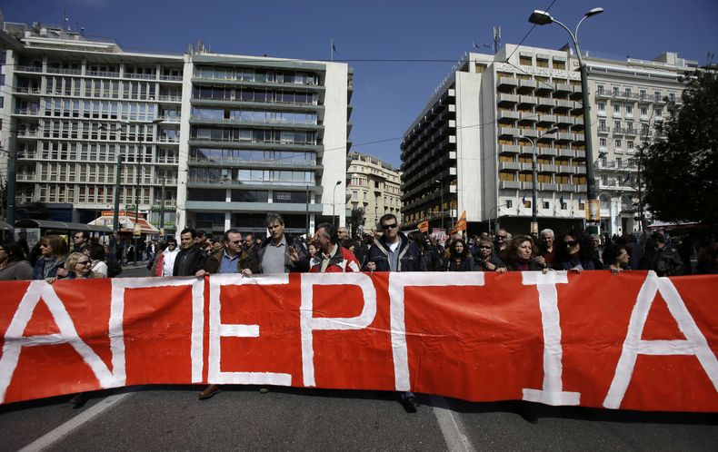 Manifestantes con un cartel que programa "Huelga" en Atenas el mi&eacute;rcoles, 12 de marzo del 2014. (Foto AP/Thanassis Stavrakis)