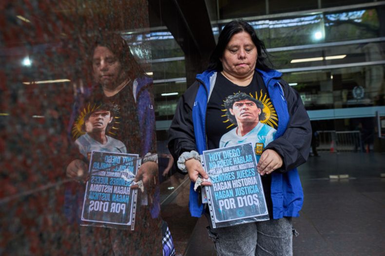 María Mellado, admiradora del fallecido Diego Maradona, afuera de la entrada del tribunal donde se realiza el juicio por negligencia contra el personal médico que atendió al astro del fútbol, el miércoles 21 de octubre de 2026, en San Isidro, Buenos Aires, Argentina. (AP Foto/Rodrigo Abd)