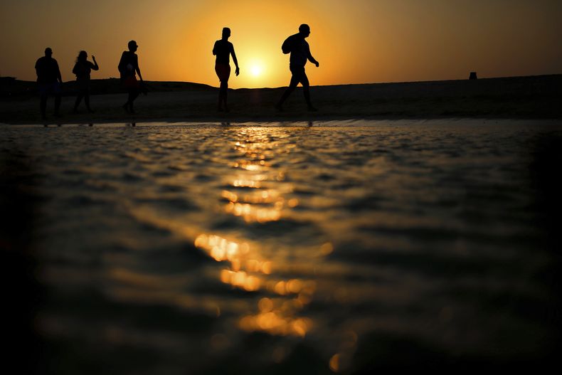 ARCHIO - Turistas caminan por la playa de la isla Giftun mientras se pone el sol sobre el mar Rojo en Hurghada, Egipto, el jueves 20 de agosto de 2015. (AP Foto/Hassan Ammar, Archivo)