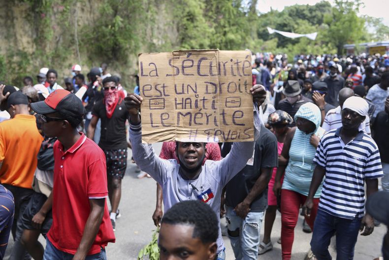Un manifestante sostiene una pancarta con la leyenda en francés: La seguridad es un derecho, Haití lo merece, durante una protesta contra la inseguridad, el miércoles 2 de abril de 2025, en Puerto Príncipe, Haití. (AP Foto/Odelyn Joseph)