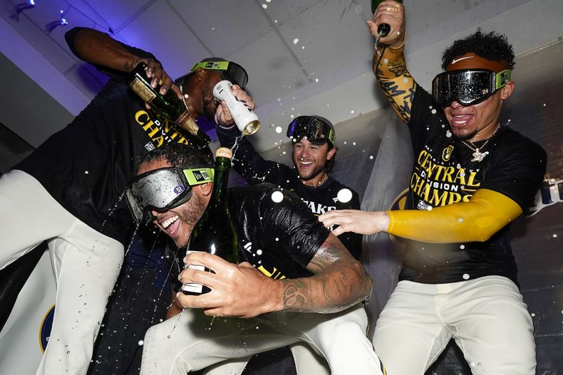 El dominicano Freddy Peralta es bañado con champaña por sus compañeros de los Cerveceros de Milwaukee, tras la conquista del título divisional, el martes 26 de septiembre de 2023, en un duelo ante los Cardenales de San Luis (AP Foto/Morry Gash)