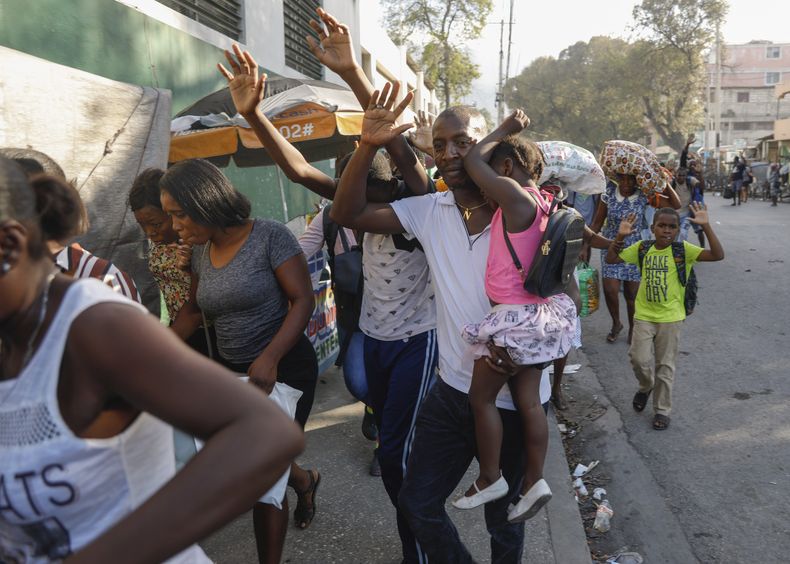 ARCHIVO - Vecinos huyen de sus casas durante los enfrentamientos entre la policía y miembros de una pandilla en el barrio de Portail en Puerto Príncipe, Haití, el jueves 29 de febrero de 2024. (AP Foto/Odelyn Joseph, Archivo)