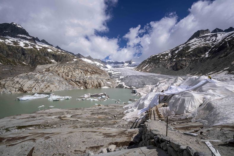 Trozos de hielo flotan en un lago frente al Glaciar Rhone cerca de Goms, Suiza, el jueves 15 de junio de 2023. (AP Foto/Matthias Schrader)