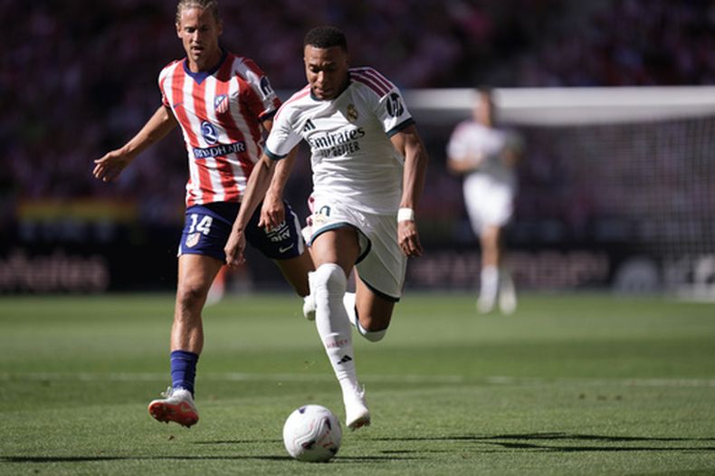 Kylian Mbappé del Real Madrid deja atrás a Marcos Llorente del Atlético de Madrid en el partido de la Liga española, el domingo 20 de septiembre de 2026, en Madrid. (AP Foto/Bernat Armangue)