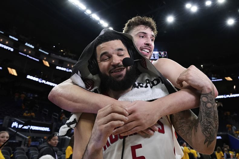 Fred VanVleet recibe un abrazo de Alperen Sengun, su compañero en los Rockets de Hosuton, luego de vencer a los Warriors de Golden State en el sexto partido de su serie de playoffs, el viernes 2 de mayo de 2025 (AP Foto/Godofredo A. Vásquez)