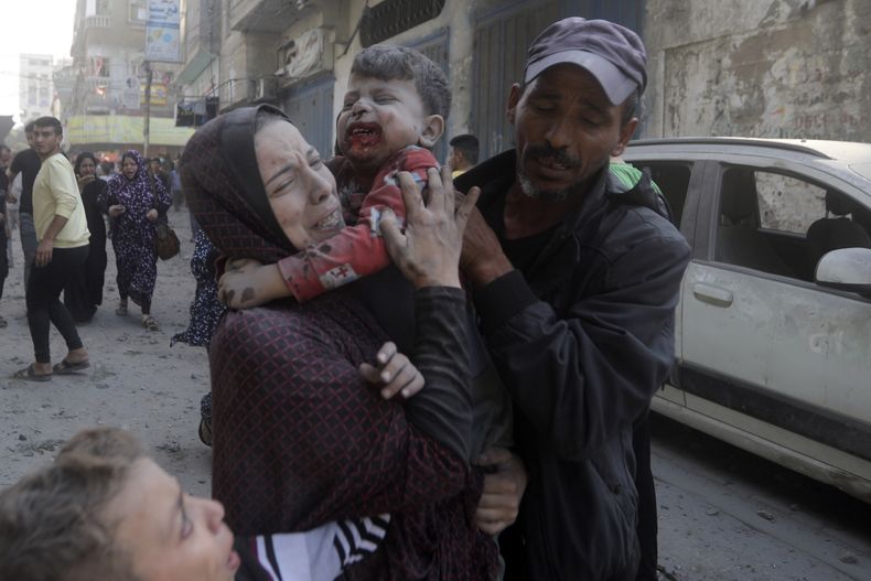 Una palestina llora mientras carga a su hijo herido tras un ataque aéreo israelí el jueves 2 de noviembre de 2023, en el campamento de refugiados de Bureij, en la Franja de Gaza. (AP Foto/Mohammed Dahman)