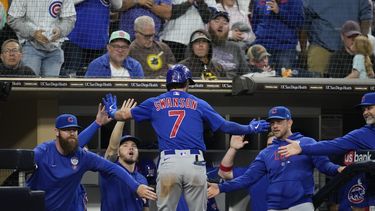 Dansby Swanson (7), de los Cachorros de Chicago, es felicitado en la caseta después de batear cuadrangular durante la quinta entrada del juego de béisbol en contra de los Padres de San Diego, el viernes 2 de junio de 2023, en San Diego. (AP Foto/Gregory Bull)