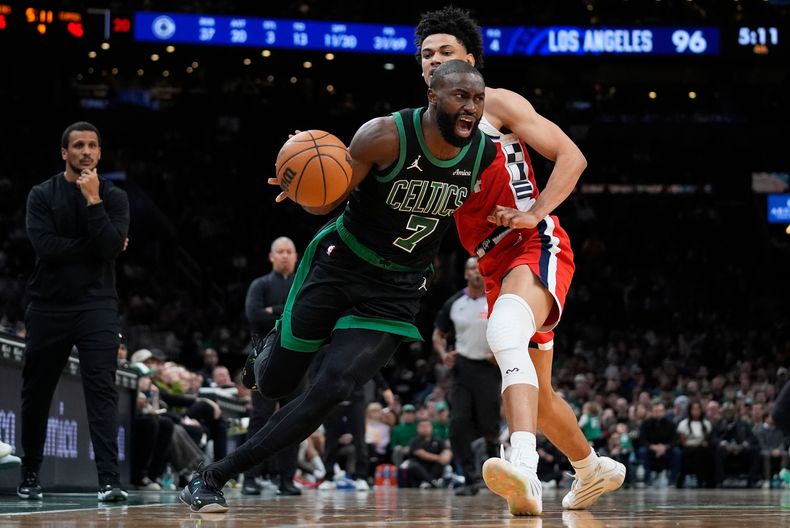 Jaylen Brown (7) de los Celtics de Boston, se enfila con el balón hacia la canasta, dejando atrás a Kobe Sanders, de los Clippers de Los Ángeles, durante la segunda mitad del juego de baloncesto de la NBA, el domingo 16 de noviembre de 2025, en Boston. (AP Foto/Robert F. Bukaty)