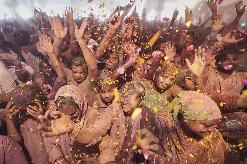 Devotos hindúes festejan el Holi, el festival hindú de los colores, en el templo Lord Jagannath, en Ahmedabad, India, el 14 de marzo de 2025. (AP Foto/Ajit Solanki)
