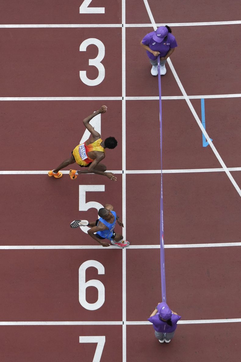 El tanzano Alphonce Felix Simbu, abajo, cruza la línea de meta por delante del alemán Amanal Petros para ganar el maratón masculino en el Campeonato Mundial de Atletismo en Tokio, el lunes 15 de septiembre de 2025. (AP Photo/Bernat Armangue)