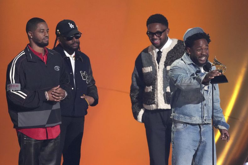 Kendrick Lamar, centro, acepta el premio a la canción del año por Not Like Us durante la 67ª entrega anual de los Grammy el domingo 2 de febrero de 2025 en Los Ángeles. Dave Free, de izquierda a derecha, Soundwave y Mustard miran desde la parte trasera del escenario. (Foto AP/Chris Pizzello)