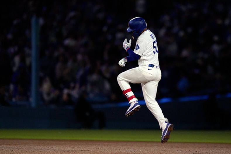Mookie Betts, de los Dodgers de Los Ángeles, salta para festejar un jonrón de tres carreras ante los Rockies de Colorado, el martes 26 de mayo de 2026 (AP Foto/Mark J. Terrill)