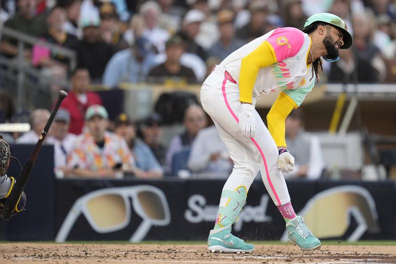 Fernando Tatis Jr., de los Padres de San Diego, hace una mueca después de ser golpeado por un lanzamiento durante la tercera entrada contra los Cerveceros de Milwaukee, el viernes 21 de junio de 2024, en San Diego. (AP Foto/Gregory Bull)