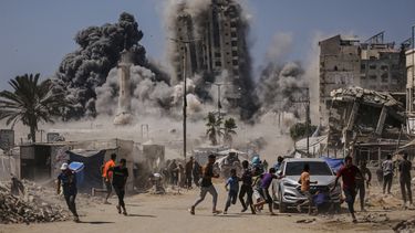 Palestinos corren para protegerse durante un ataque aéreo israelí contra un edificio de gran altura en la Ciudad de Gaza, el viernes 5 de septiembre de 2025, después de que Israel lanzara una advertencia previa. (AP Foto/Yousef Al Zanoun)