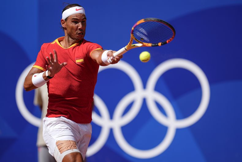 ARCHIVO - El español Rafael Nadal devuelve una pelota frente a Marton Fucsovics, de Hungría, durante el torneo masculino de tenis en los Juegos Olímpicos de 2024, el domingo 28 de julio de 2024, en París, Francia. (AP Foto/Manu Fernandez, Archivo)