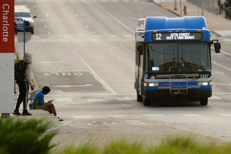 Varias personas esperan el autobús en una estación de transporte público el viernes 5 de junio de 2026 en Kansas City, Missouri. (Foto AP/Charlie Riedel)