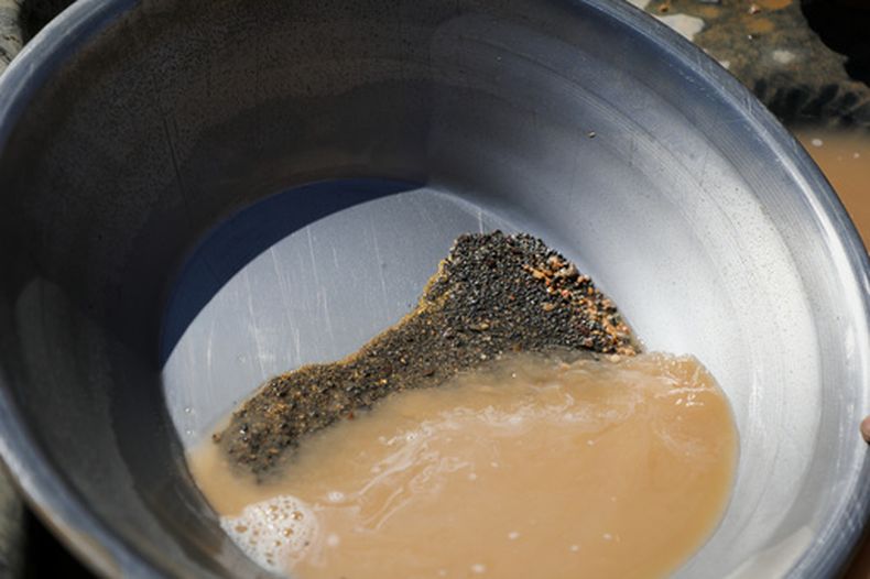 ARCHIVO - Una batea que contiene sedimentos auríferos y concentrado de minerales pesados se encuentra en un yacimiento minero artesanal en Dalago Mahas, estado del norte de Sudán, el viernes 8 de mayo de 2026. (Foto AP/Mohnd Blal, archivo)