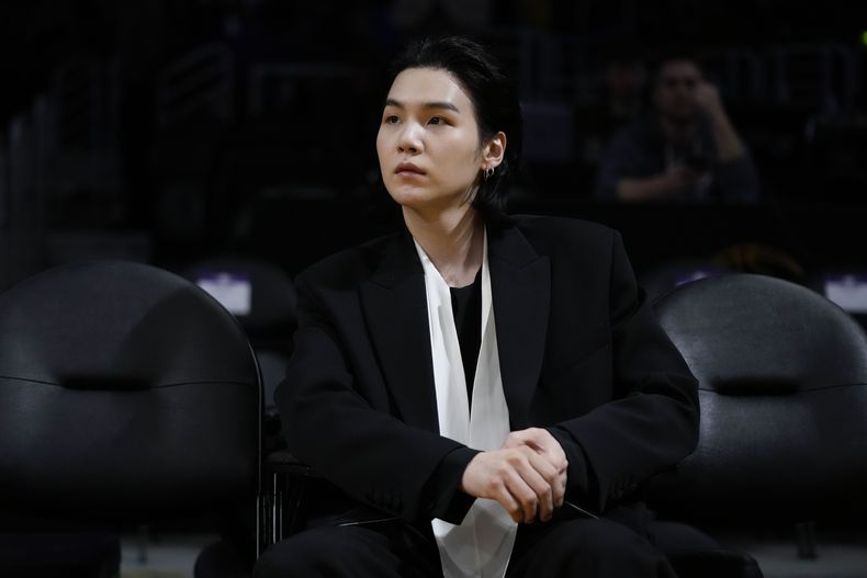 ARCHIVO - Suga, BTS, asiste a un partido de la NBA entre los Lakers de Los Angeles y los Mavericks de Dallas el 12 de enero de 2023 en Los Ángeles. Suga, el rapero, cantante y compositor superestrella del K-pop, se ha convertido en el tercer miembro de BTS en comenzar el servicio militar obligatorio de Corea del Sur dijo su sello el 7 de agosto de 2023. (Foto AP/Jae C. Hong, archivo)
