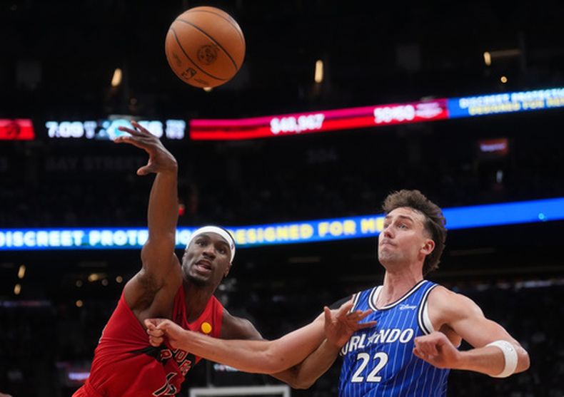 Jakobe Walter, de los Raptors de Toronto, disputa un balón ante Franz Wagner, del Magic de Orlando, el miércoles 28 de octubre de 2026 Denette/The Canadian Press via AP)
