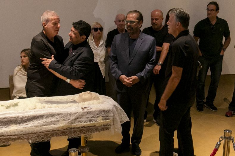 El presidente de la Confederación de Fútbol de Brasil, Ednaldo Rodrigues, abrasa a Mario César Zagallo, hijo del exentrenador y jugador de Brasil Mario Zagallo durante el funeral en las instalaciones de la confederación, el domingo 7 de enero del 2023. (AP Foto/Bruna Prado)