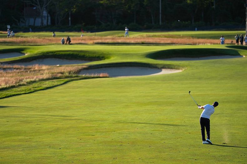 Wyndham Clark batea desde el fairway en el hoyo 15 durante la tercera ronda del torneo de golf Abierto de EE. UU. en el Shinnecock Hills Golf Club en Southampton, Nueva York, el sábado 20 de junio de 2026. (Foto AP/George Walker IV)