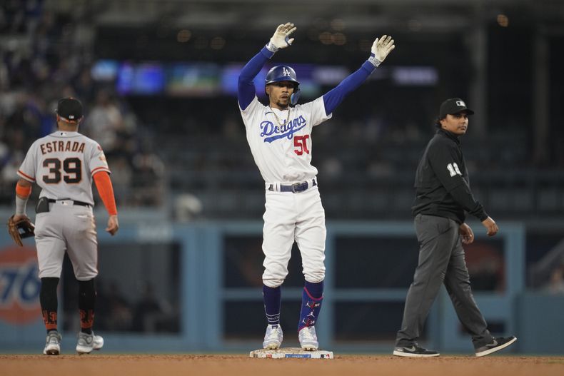 Mookie Betts, de los Dodgers de Los Ángeles, festeja luego de conectar un doble en el juego del sábado 23 de septiembre de 2023, ante los Gigantes de San Francisco (AP Foto/Ashley Landis)