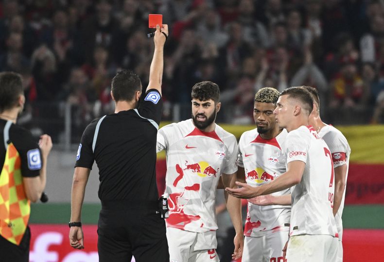El árbitro Sven Jablonski expulsa a Josko Gvardiol (centro) del Leipzig durante las semifinales de la Copa de Alemania contra Friburgo, el martes 2 de mayo de 2023. (Marijan Murat/dpa vía AP)
