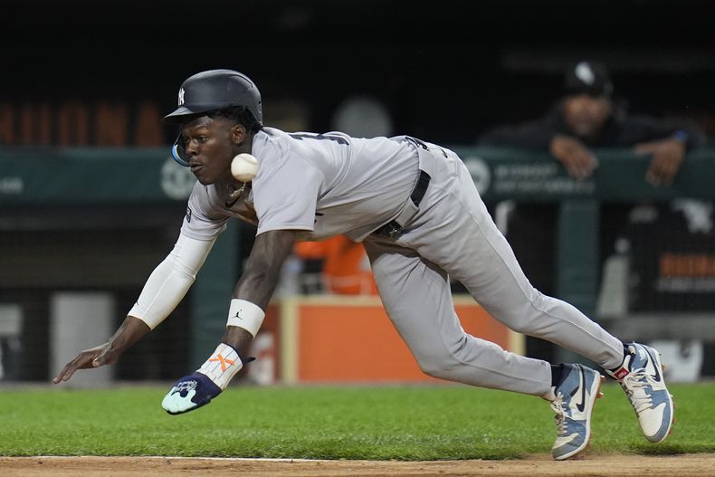 Jazz Chisholm Jr., de los Yankees de Nueva York, se barre a salvo en el plato para anotar carrera con sencillo de Anthony Volpe durante la quinta entrada del juego de béisbol en contra de los Medias Blancas de Chicago, el lunes 12 de agosto de 2024, en Chicago. (AP Foto/Erin Hooley)